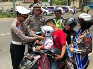 Sat Lantas Polres Payakumbuh Bagikan Helm dan Bunga bagi Pengendara